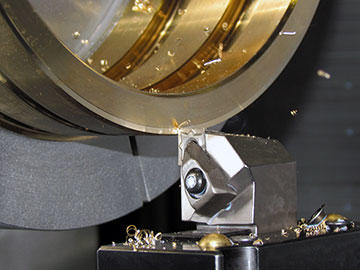 A skim cut on an upper bearing assembly – two mated halves machined together from aluminum-nickel-bronze. Because the material is unstable in machining, Vander Meyden programs a skim cut to within .010” of finish so the finishing pass keeps the part within the required ±.001” of roundness.