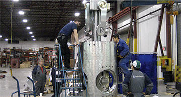 The Rolls-Royce team assembles a pitch propeller hub in its Coquitlam facility.