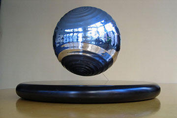 The sculpture completely assembled, with the rippled sphere magnetically levitated above its base, kept from being knocked away from the base’s magnetic field by a .018” cable tether, displayed as presented to rock star Bono, president Bill Clinton, and other TED Award recipients.